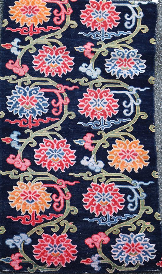 A Tibetan lotus rug, 5ft 6in. x 2ft 11in.